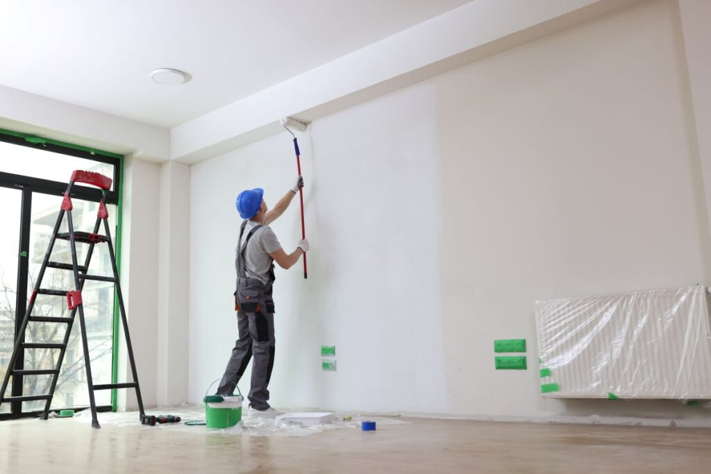 Painter painting interior walls with a roller in Reno, Nevada